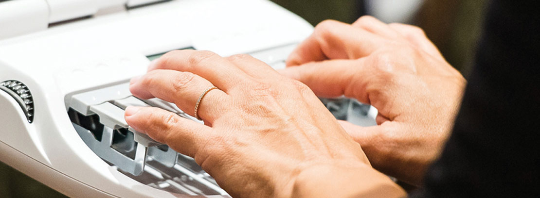 close up of hands on a stenographic machine